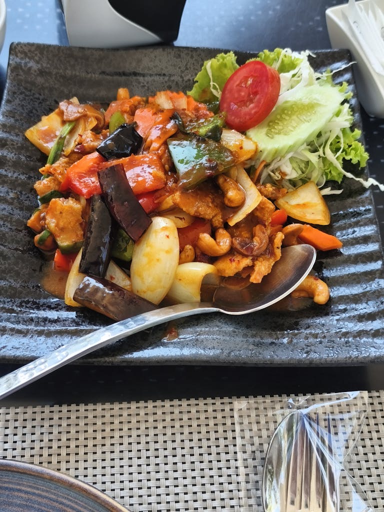 A colorful Thai vegetable stir-fry with cashews, served in Muang Pattaya, Thailand.