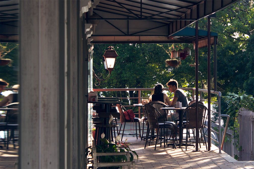 Couple enjoying a peaceful day at an outdoor café in Centro, Brazil.