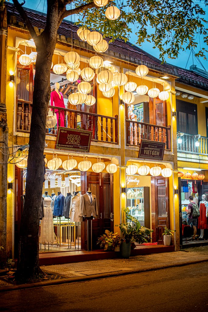 Evening view of a boutique in Hội An, Vietnam, adorned with lanterns and traditional architecture.