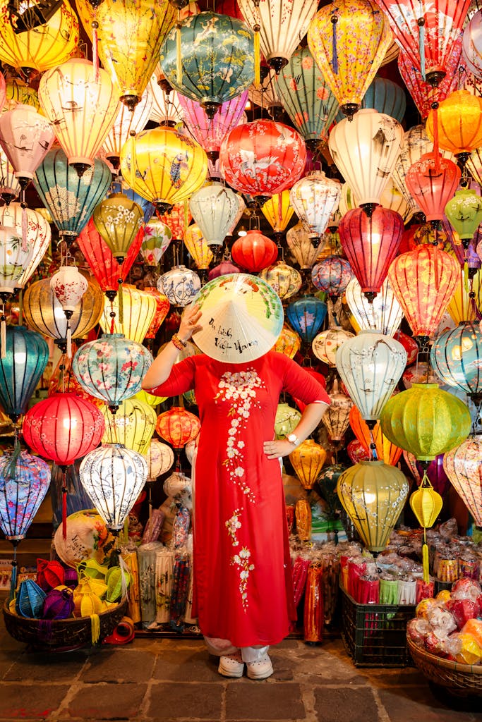 Explore the vibrant colors of Hội An with a traditional Ao Dai surrounded by beautiful lanterns.