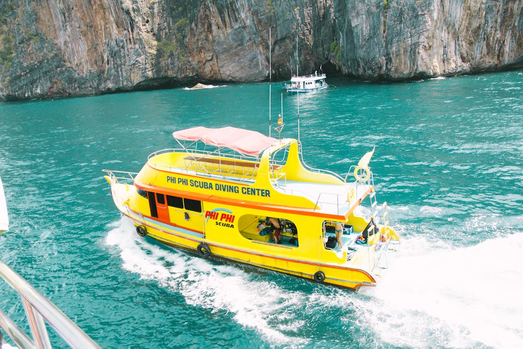 Scuba diving tour boat cruising the turquoise waters of Phi Phi Islands, Thailand.