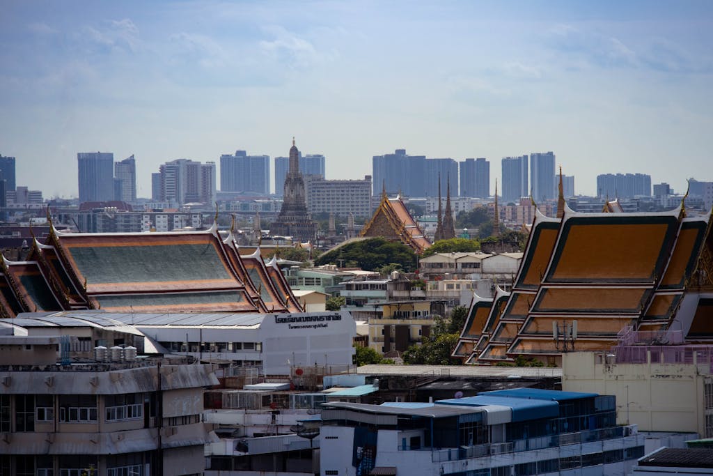 Skyline view of Bangkok highlighting traditional Thai architecture amidst modern buildings.