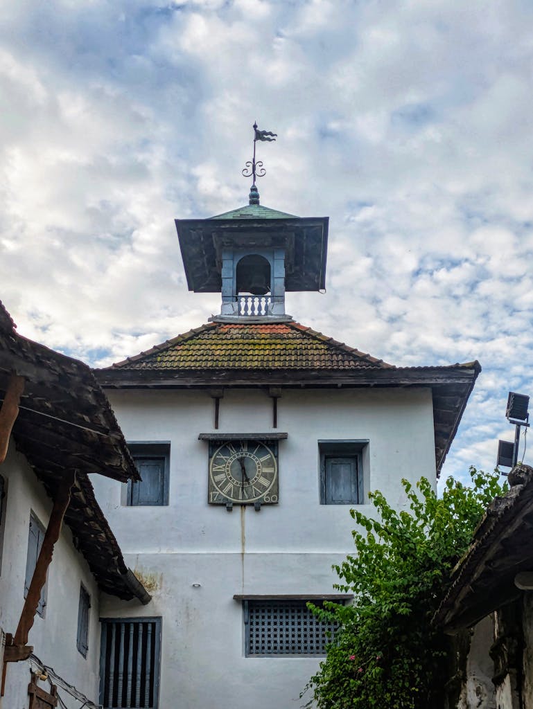 Stunning view of the Paradesi Synagogue clock tower in Fort Kochi, Kerala, showcasing its historical architecture.