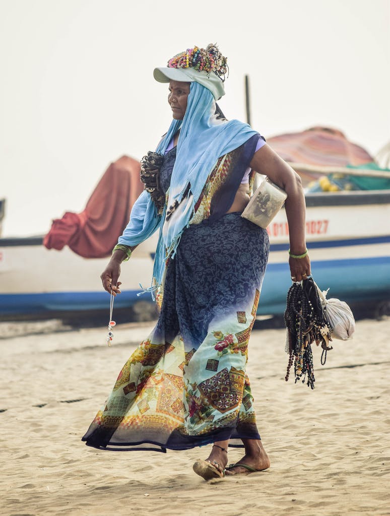 A vibrant scene of a female vendor with ornaments on a Goa beach, embodying coastal culture.