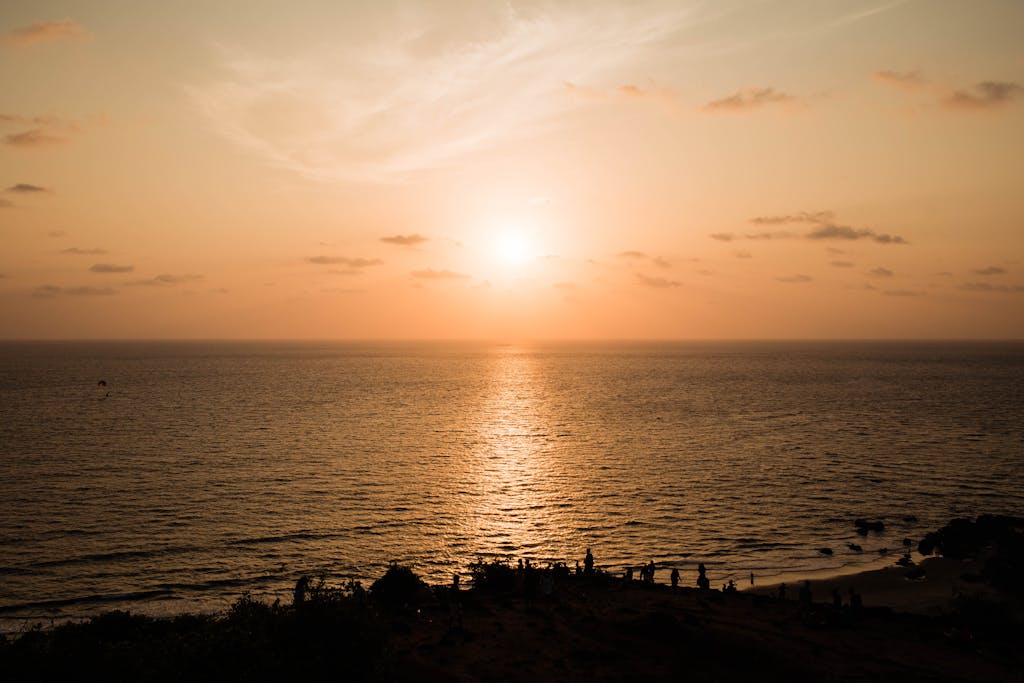 Beautiful sunset over the Arabian Sea at Chapora Beach, India, with a serene ocean view.