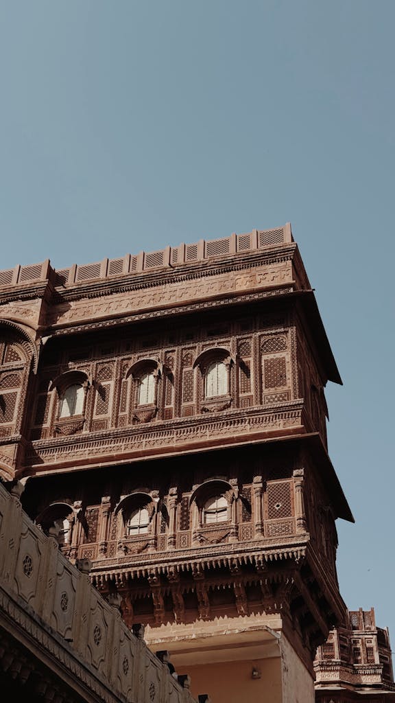 Captivating view of Mehrangarh Fort's intricate architecture against a clear blue sky in Jodhpur, India.