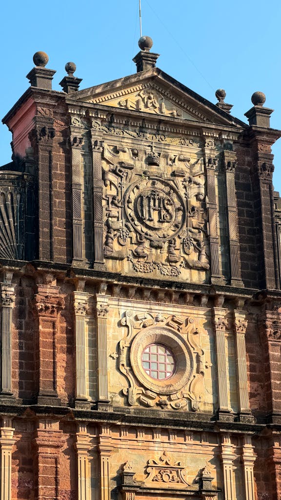 Detailed view of the Basilica of Bom Jesus facade in Goa, showcasing colonial architecture in bright daylight.