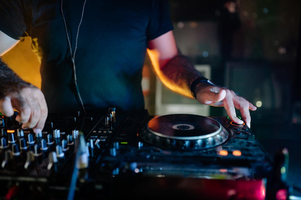 DJ mixing tracks in a vibrant nightclub setting, full of energy and music.